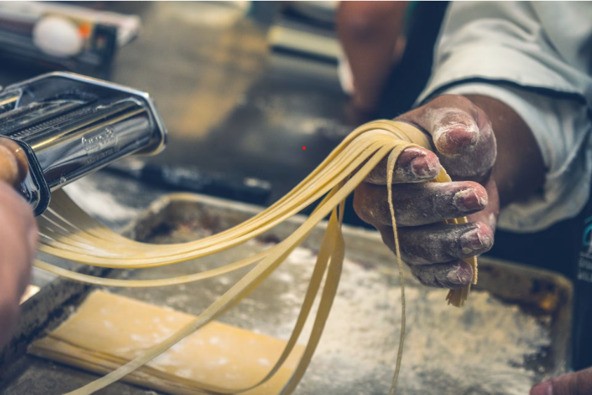 Hands making fresh Tuscan pasta